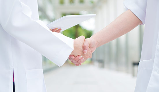 握手している二人の医師